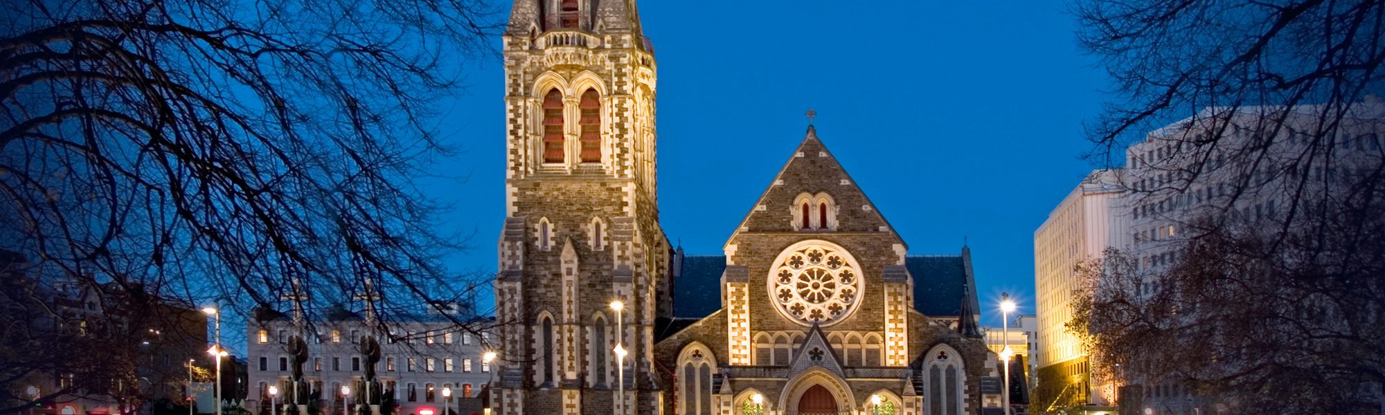 Christ Church Cathedral floodlit at dusk in Cathedral Square