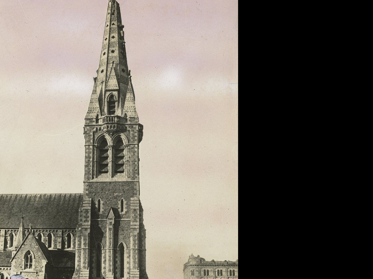 Christ Church Cathedral spire showing damage after the 1888 earthquake, with a crowd in the Square